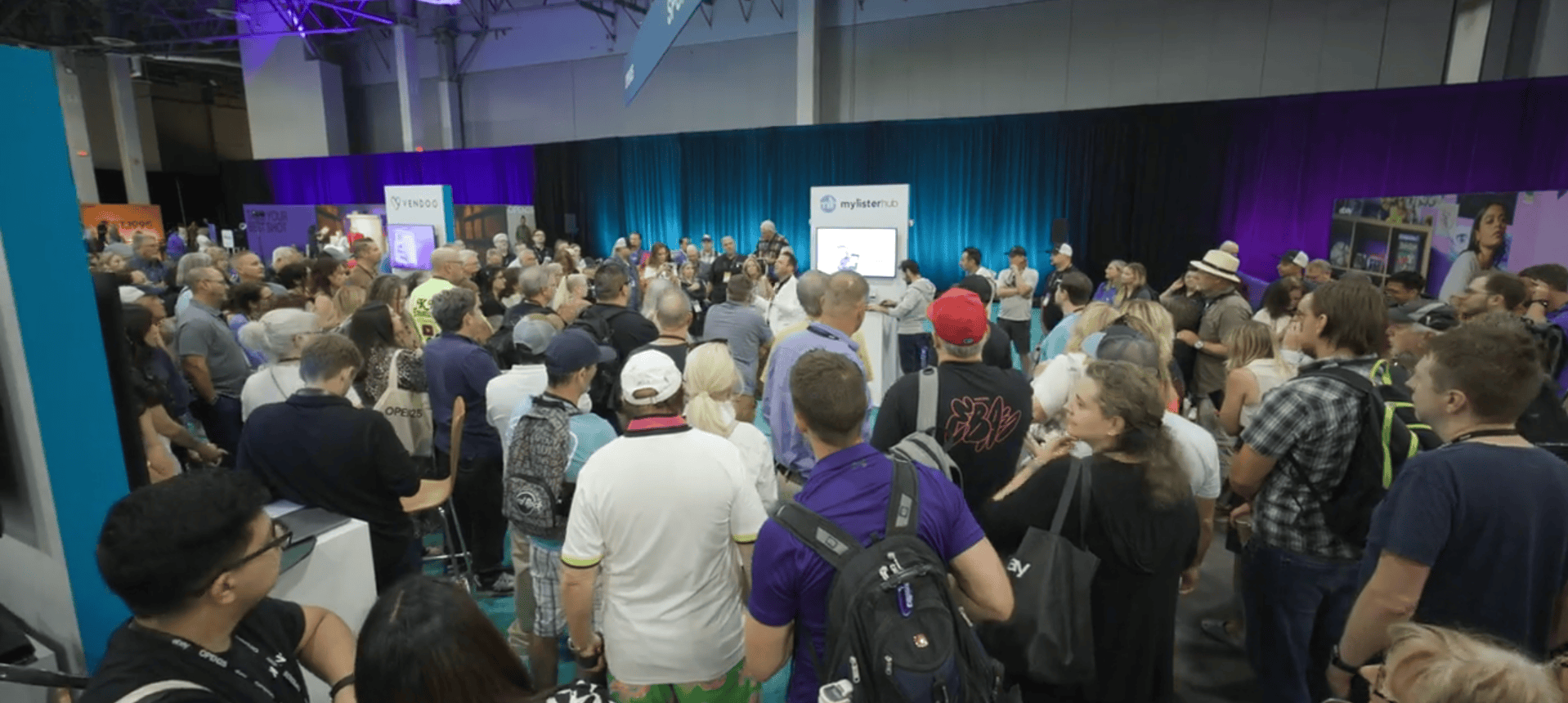 MyListerHub team giving a live AI demo to hundreds of eBay sellers gathered around the booth at eBay Open 2025